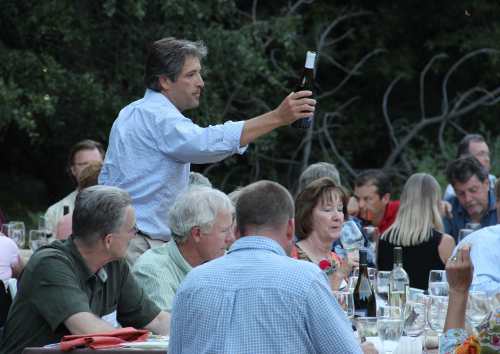 Lake County Winegrape Commission Chair Peter Molnar passes a bottle of Lake County Cabernet Sauvignon at a special dinner atop Mt. Konocti near Kelseyville, Calif., on Saturday, August 27, 2011. Photo by Casey Carney